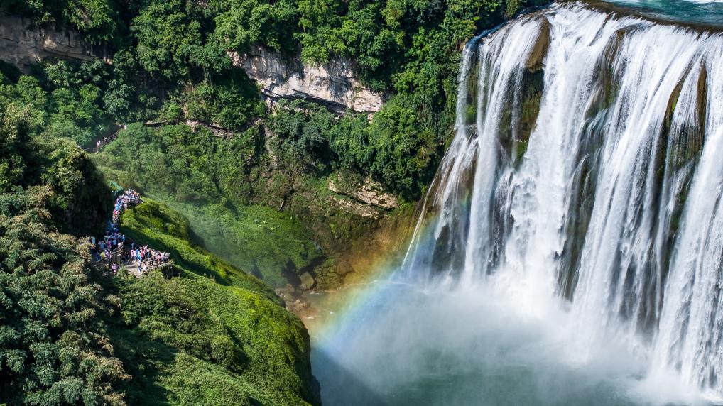 Tourists visit Huangguoshu waterfall scenic area in Anshun, SW China