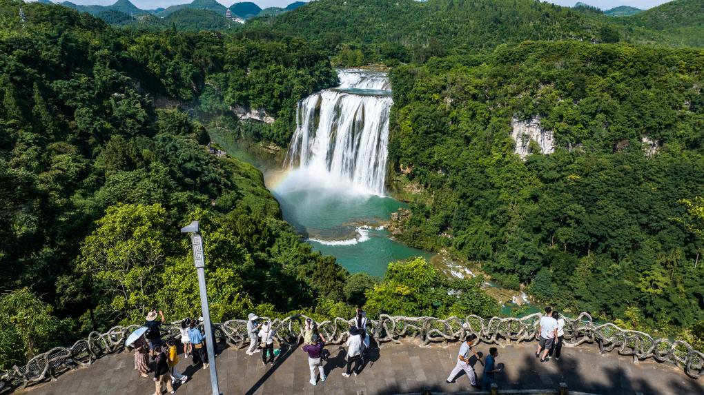 Tourists visit Huangguoshu waterfall scenic area in Anshun, SW China