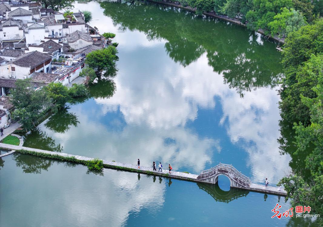 Picturesque reflections merge sky and water at Hongcun Village in E China's Anhui