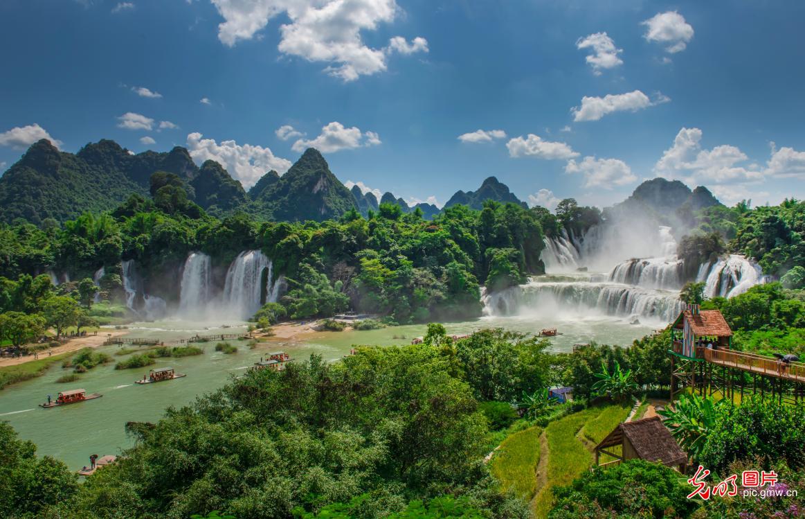 Tourists flock to Detian Waterfall as summer rains swell its majestic flow