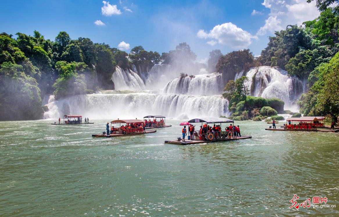 Tourists flock to Detian Waterfall as summer rains swell its majestic flow