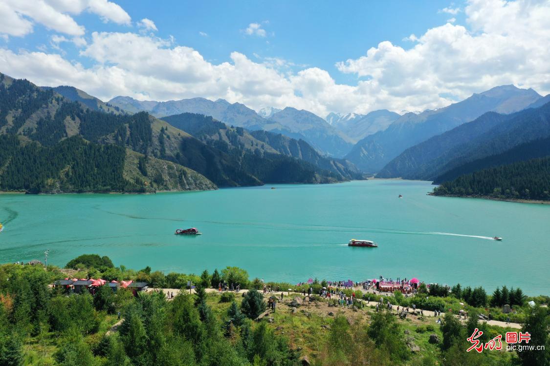 Tourists boat Tianchi Lake in SW China's Xinjiang