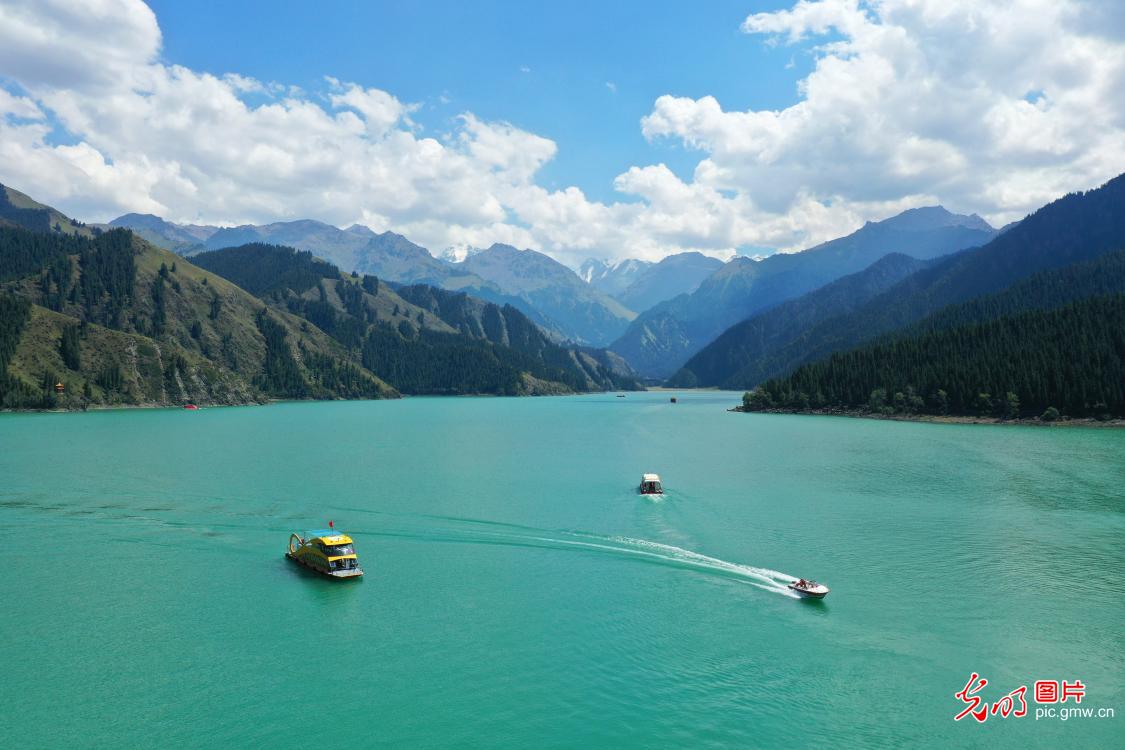 Tourists boat Tianchi Lake in SW China's Xinjiang