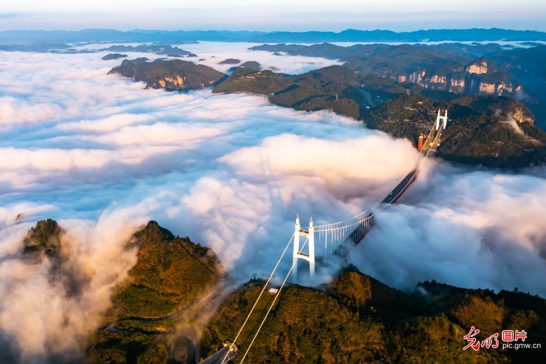 Morning mist and sunrise shroud Aizhai Suspension Bridge in central China's Hunan