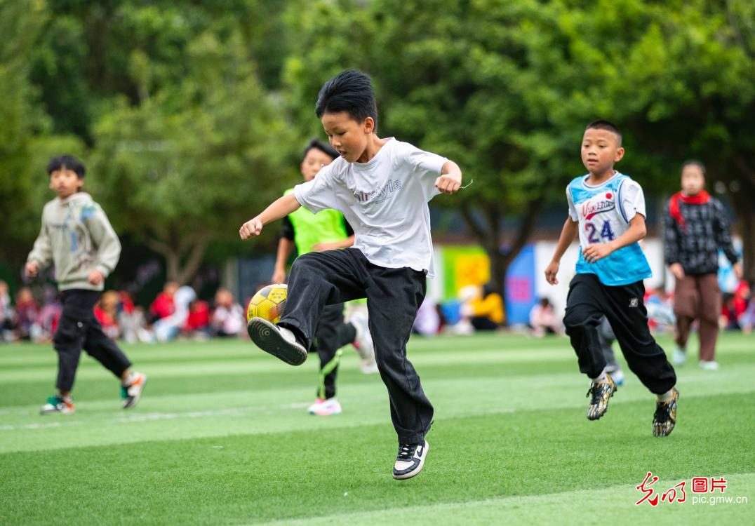 Young players practice football in SW China's Guizhou