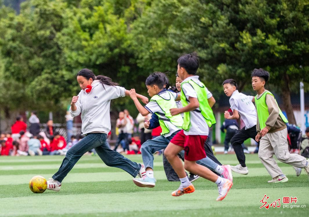 Young players practice football in SW China's Guizhou