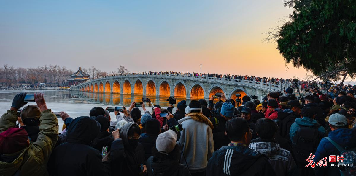 Sunset streams through Seventeen-Arch Bridge at Beijing's Summer Palace
