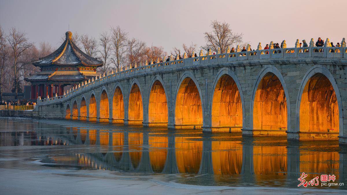 Sunset streams through Seventeen-Arch Bridge at Beijing's Summer Palace
