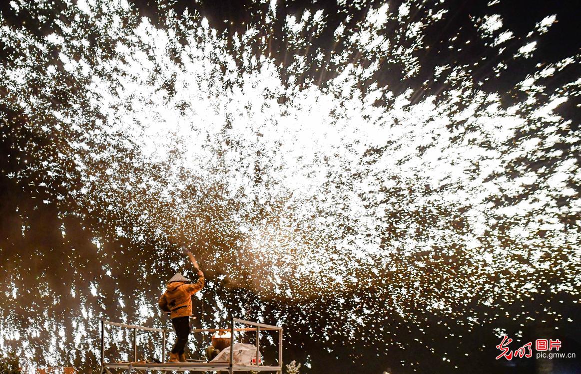 Molten iron sparks light up ice and snow festival in Inner Mongolia