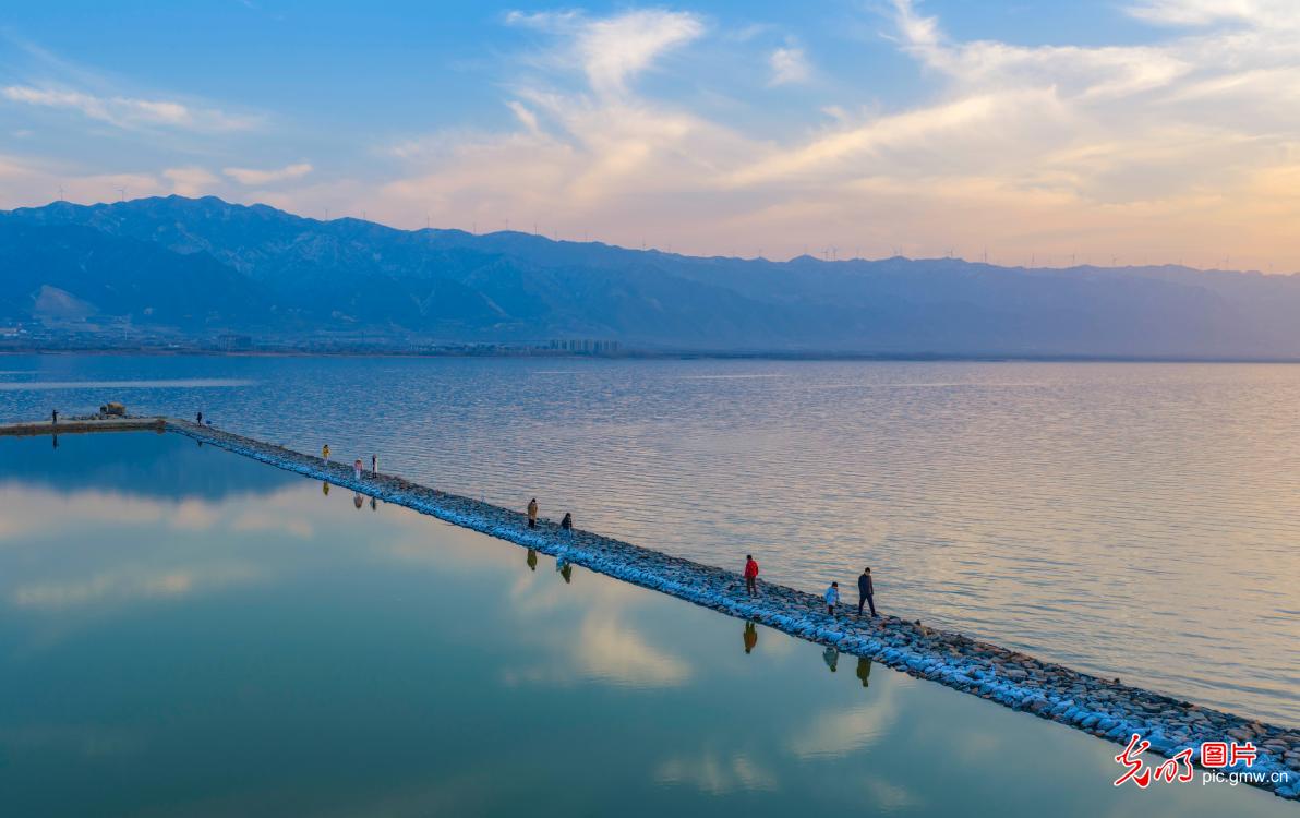 Colorful salt lake reflects winter sky