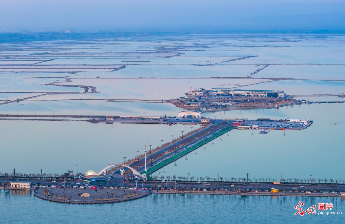 Colorful salt lake reflects winter sky