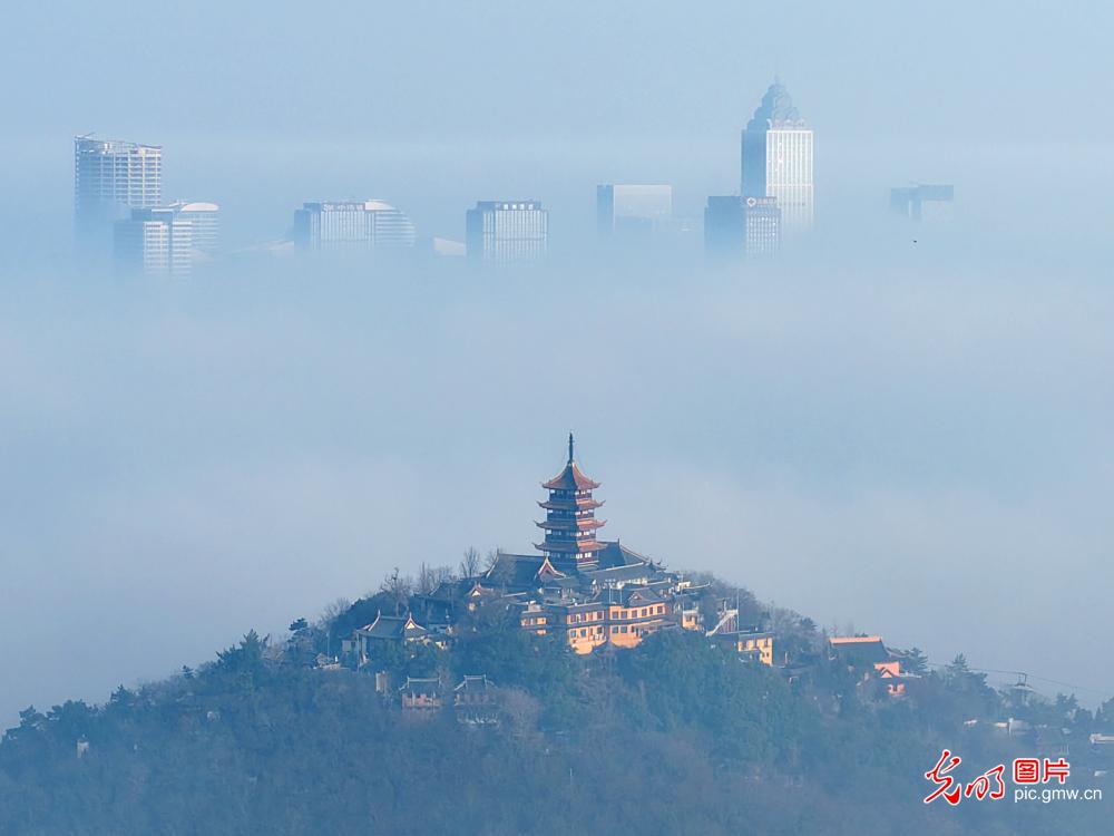 Morning mist drapes urban skyline in E China's Jiangsu