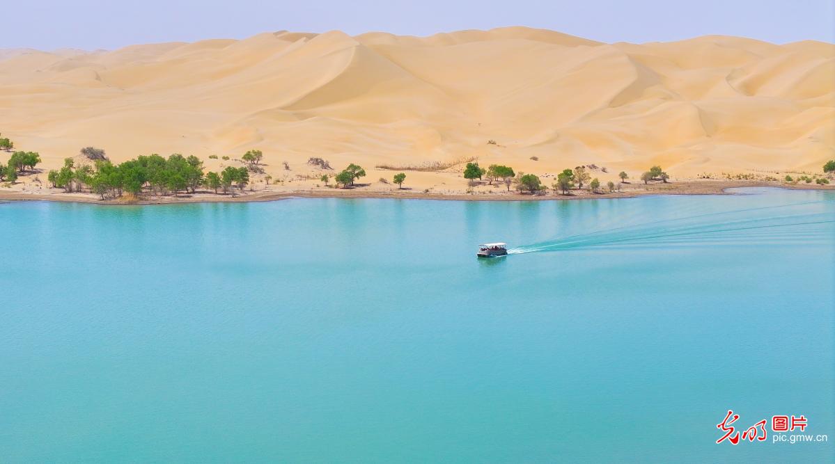 Desert and lake scenery unfold at Luobu Lake in Xinjiang