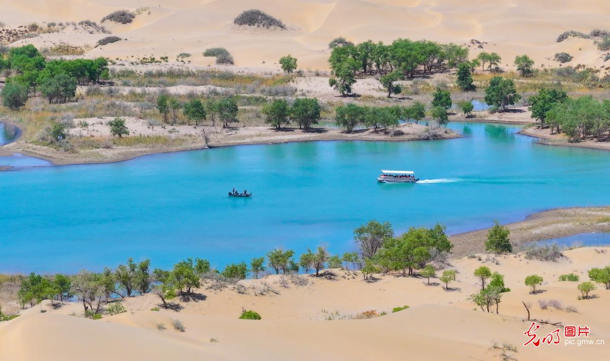Desert and lake scenery unfold at Luobu Lake in Xinjiang