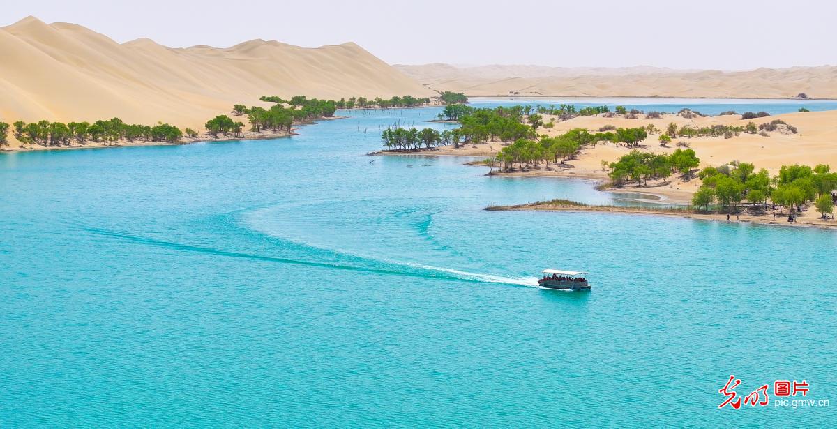 Desert and lake scenery unfold at Luobu Lake in Xinjiang