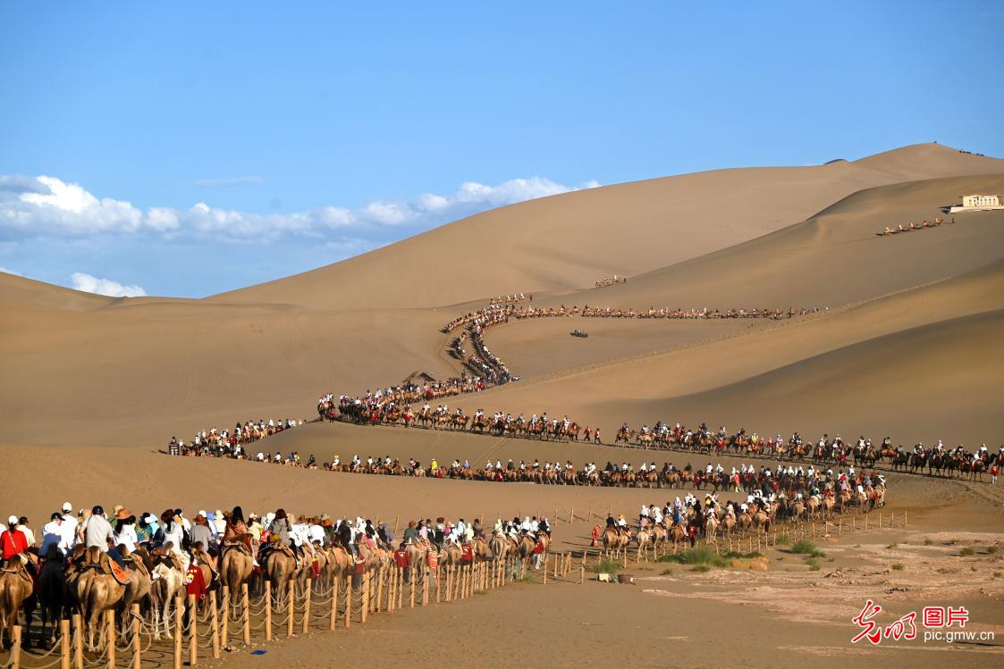 Tourists flock to Mingsha Mountain and Crescent Spring in NW China's Gansu Tourists flock to Mingsha Mountain and Crescent Spring in NW China's Gansu