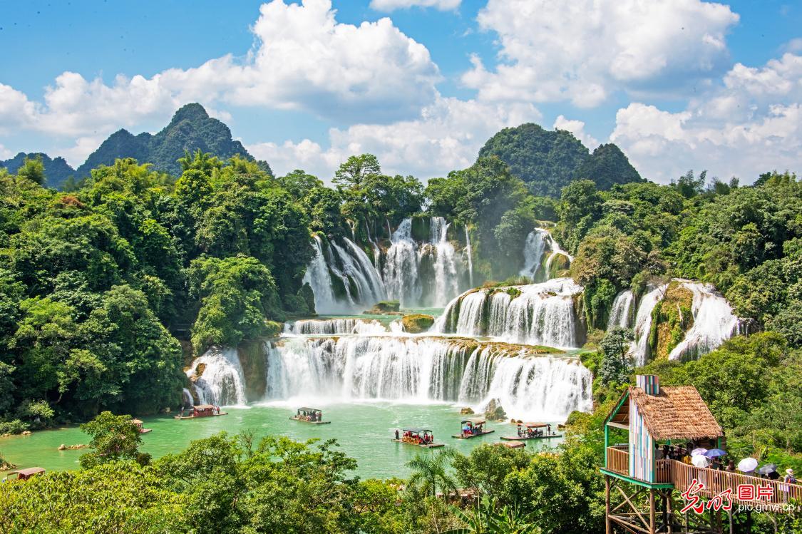 Tourists enjoy scenic views at waterfall in S China's Guangxi Tourists enjoy scenic views at waterfall in S China's Guangxi