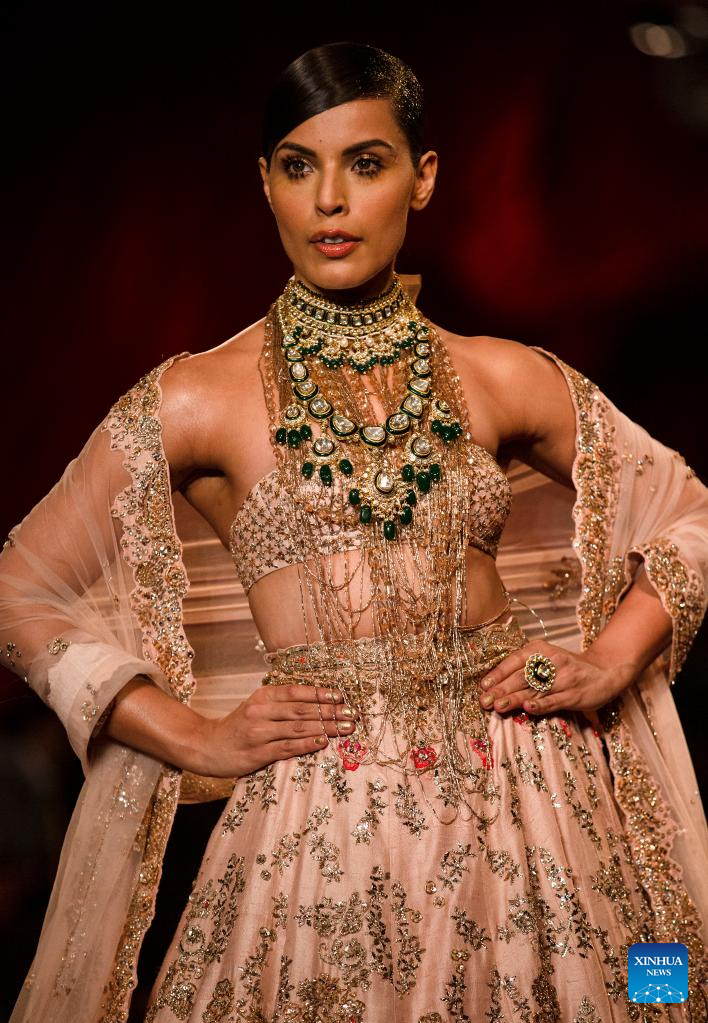 Models display creations by Indian designer Dolly J during FDCI India Couture Week