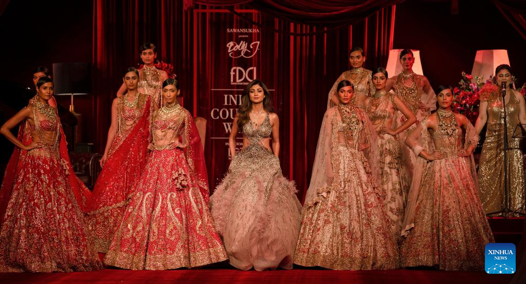 Models display creations by Indian designer Dolly J during FDCI India Couture Week
