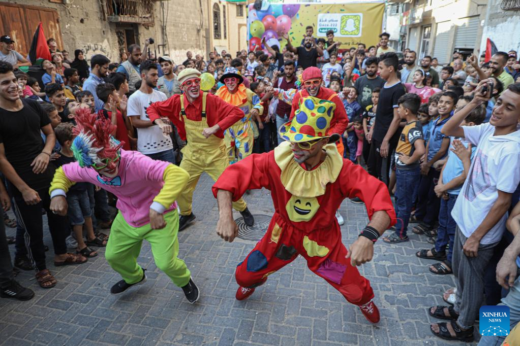 Palestinian young men dress as clowns to entertain children in northern Gaza Strip
