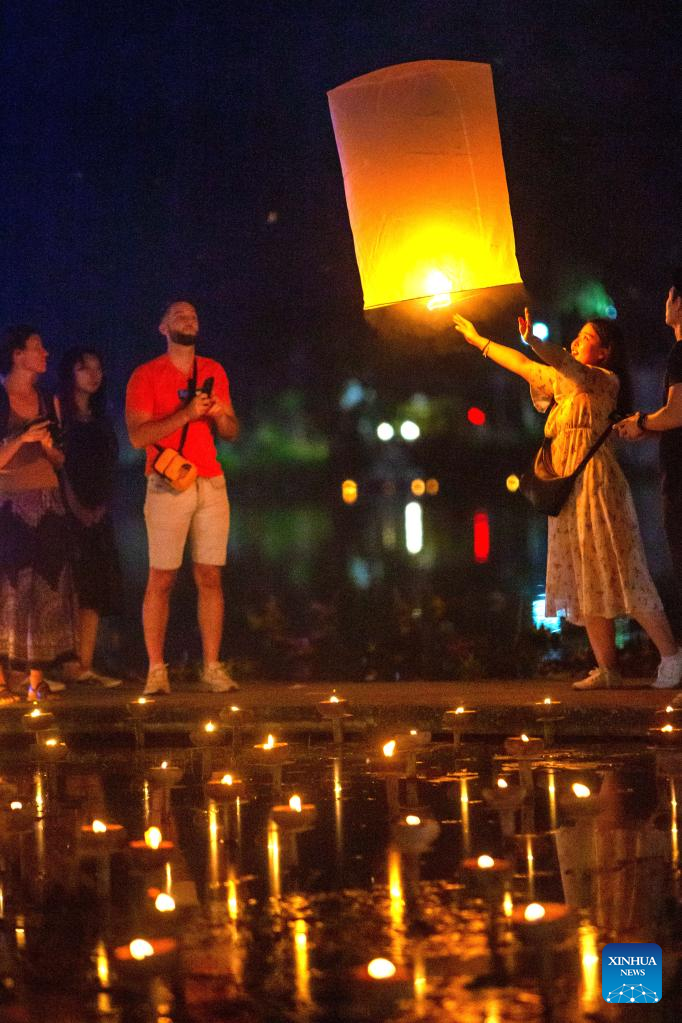People release sky lantern to make wish for good fortune in Chiang Mai, Thailand