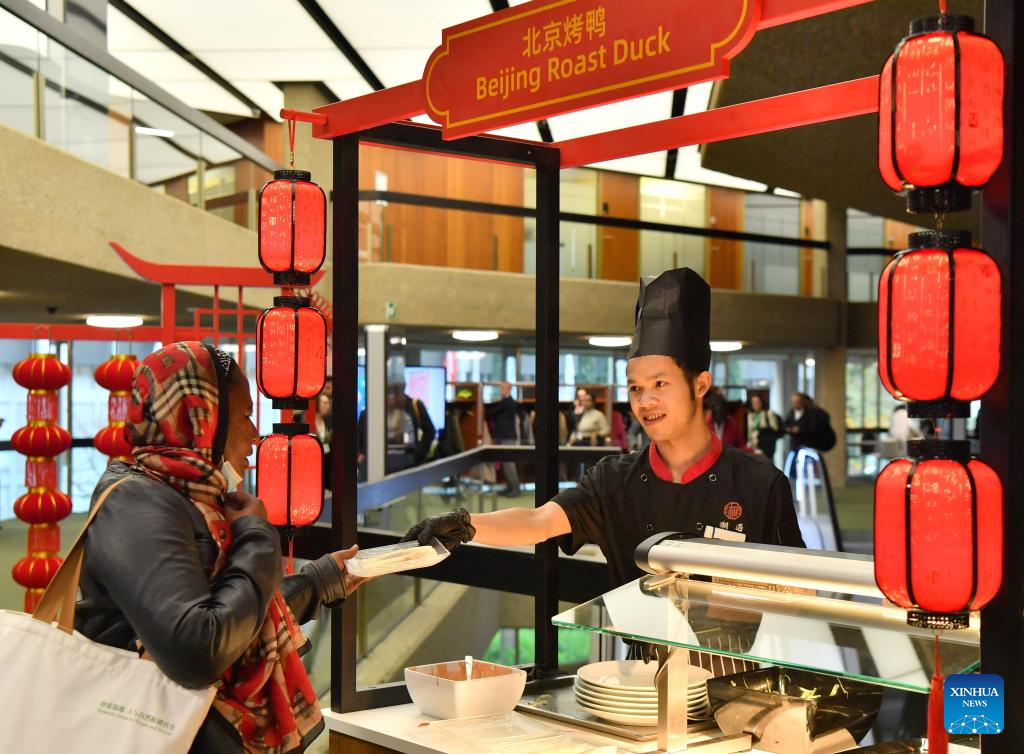 Visitors taste Chinese food during COP14 in Geneva, Switzerland