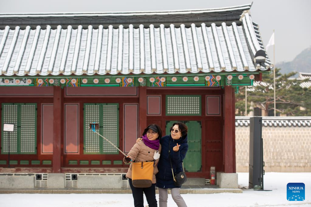 Tourists visit Gyeongbokgung Palace in snow in Seoul