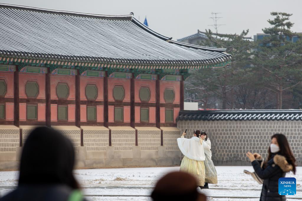 Tourists visit Gyeongbokgung Palace in snow in Seoul