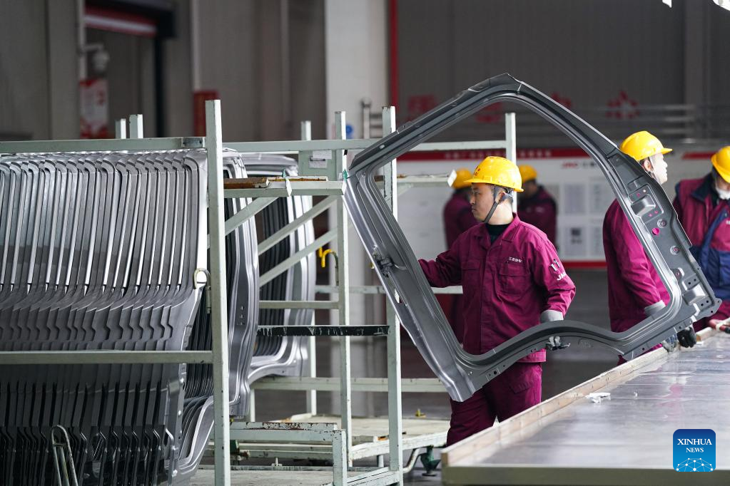 Employees busy working on truck assembly line at production base in Anhui