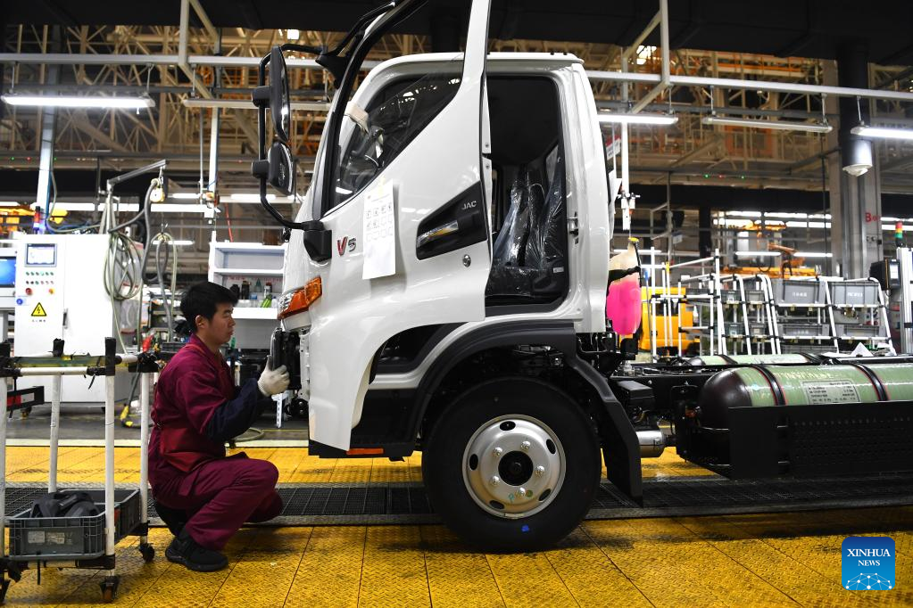 Employees busy working on truck assembly line at production base in Anhui