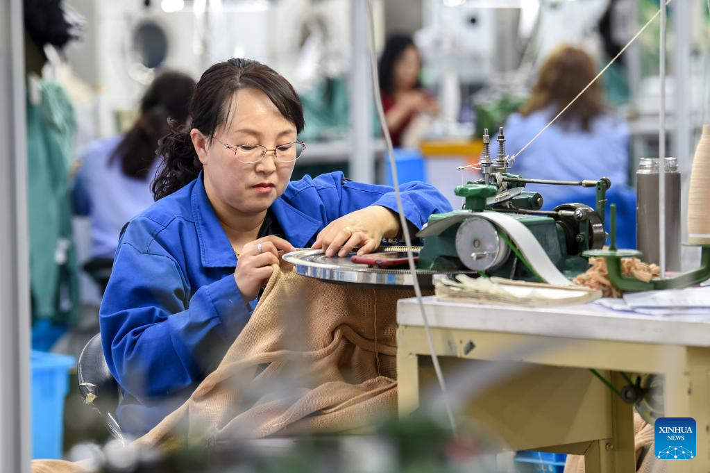 Staff members work at factory of Erdos Cashmere Group in China's Inner Mongolia