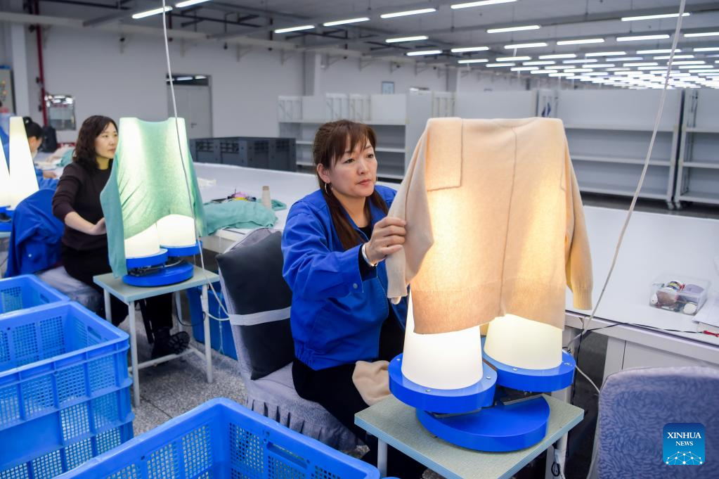 Staff members work at factory of Erdos Cashmere Group in China's Inner Mongolia