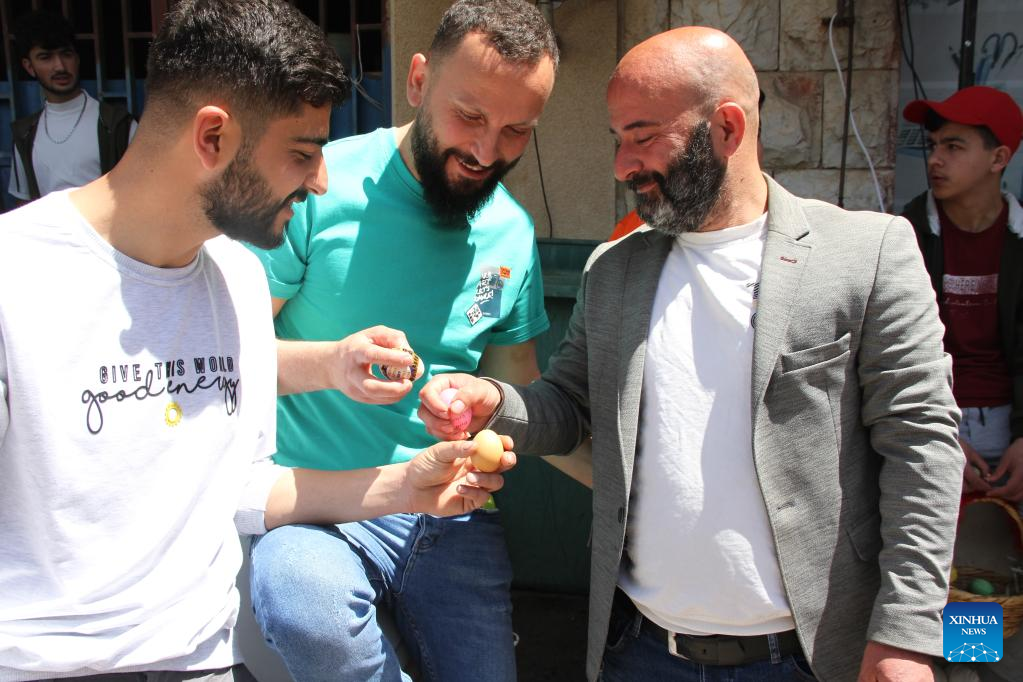 People in south Lebanon play egg tapping to celebrate Easter