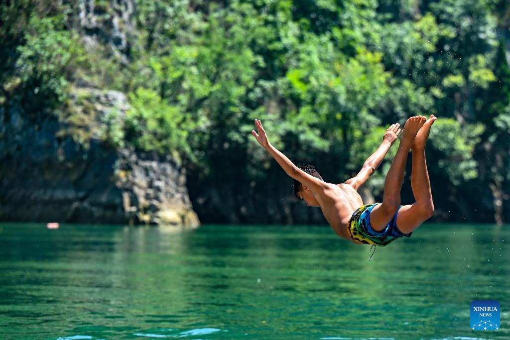 People dive at river Treska near Skopje, North Macedonia