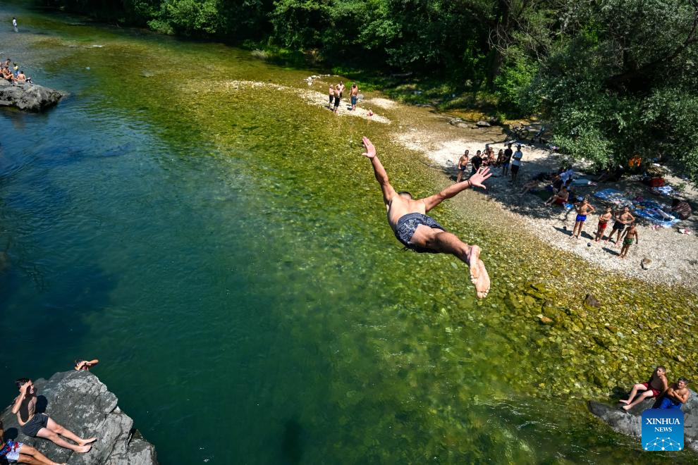 People dive at river Treska near Skopje, North Macedonia