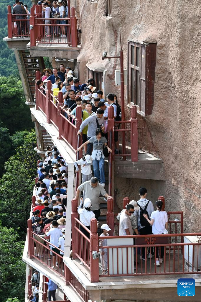 People visit Maijishan Grottoes in Tianshui City, NW China