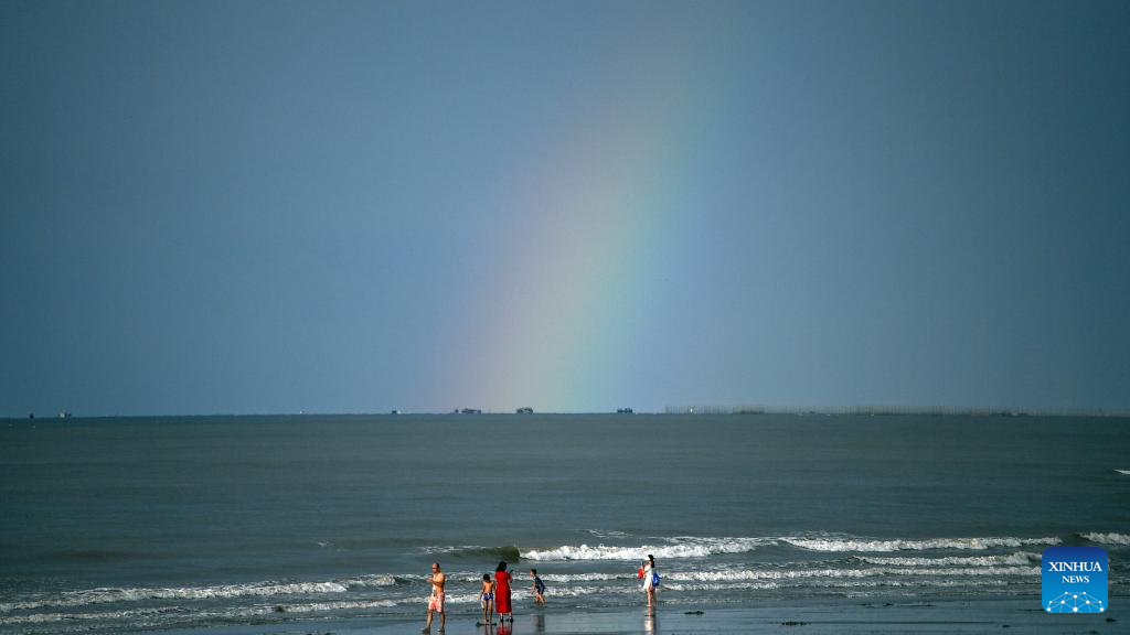 Tourists have fun at Jintan beach in Dongxing, S China's Guangxi