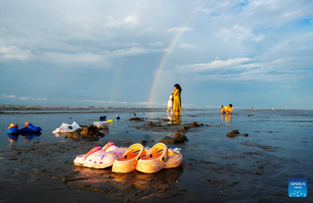 Tourists have fun at Jintan beach in Dongxing, S China's Guangxi