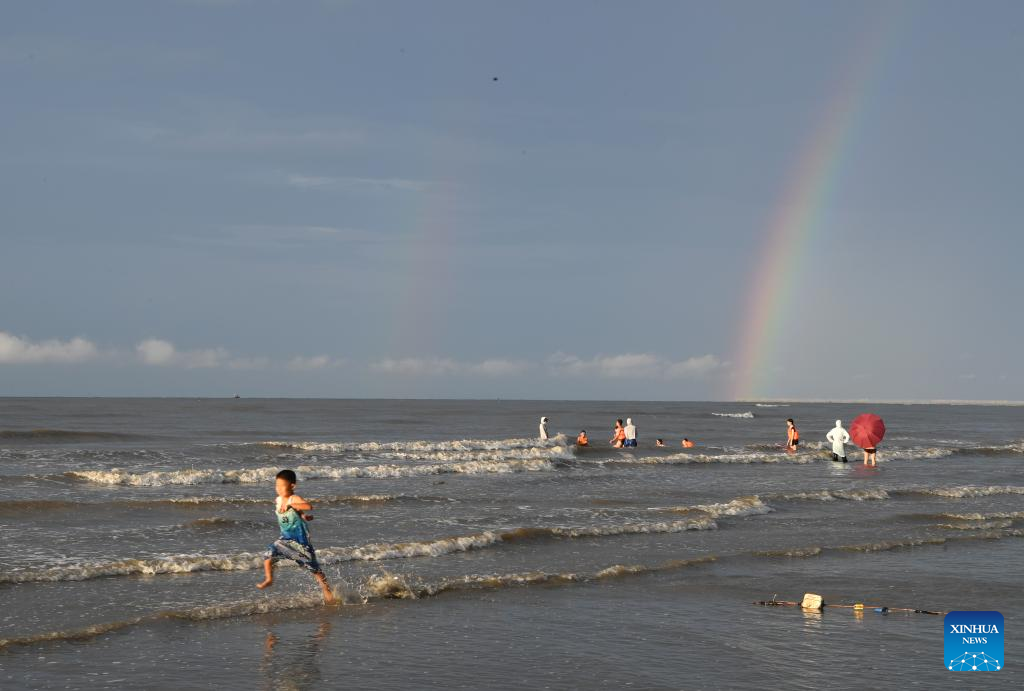 Tourists have fun at Jintan beach in Dongxing, S China's Guangxi
