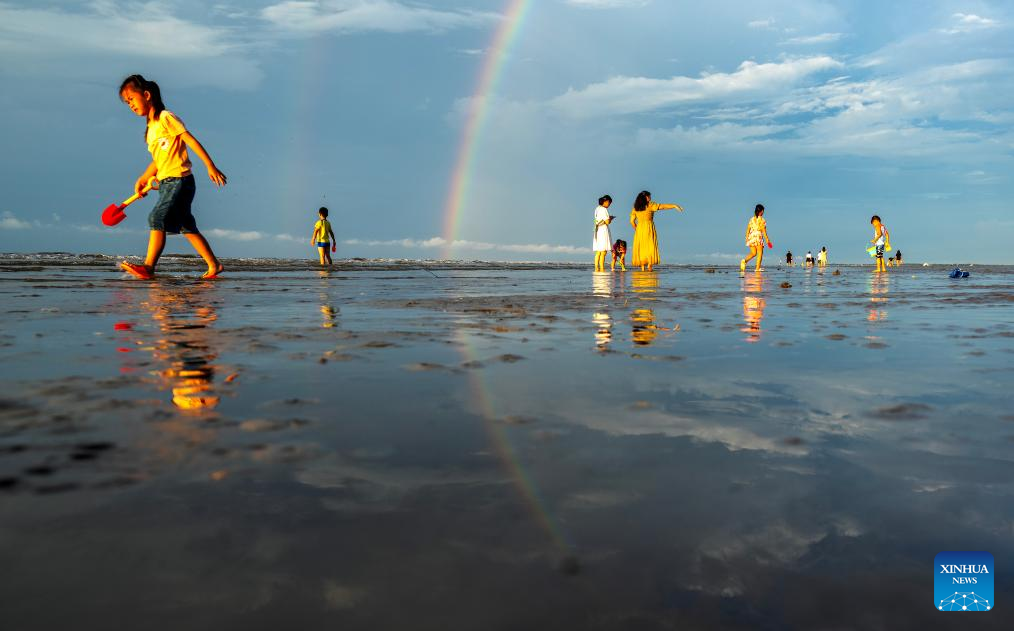 Tourists have fun at Jintan beach in Dongxing, S China's Guangxi