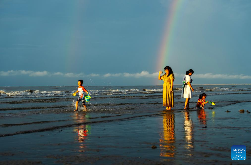 Tourists have fun at Jintan beach in Dongxing, S China's Guangxi