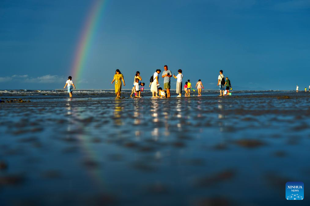 Tourists have fun at Jintan beach in Dongxing, S China's Guangxi
