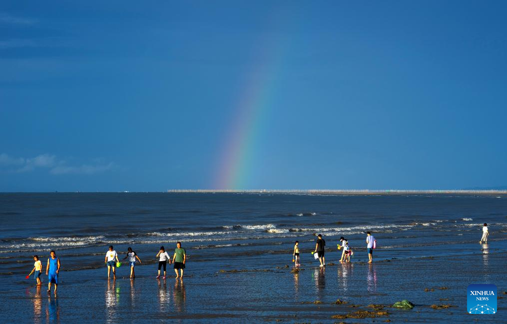 Tourists have fun at Jintan beach in Dongxing, S China's Guangxi