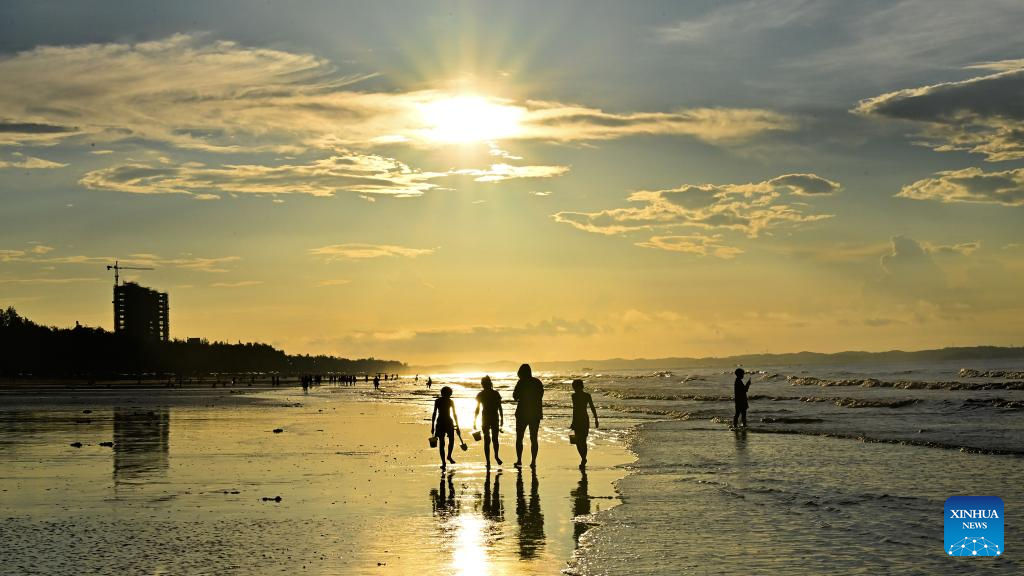 Tourists have fun at Jintan beach in Dongxing, S China's Guangxi