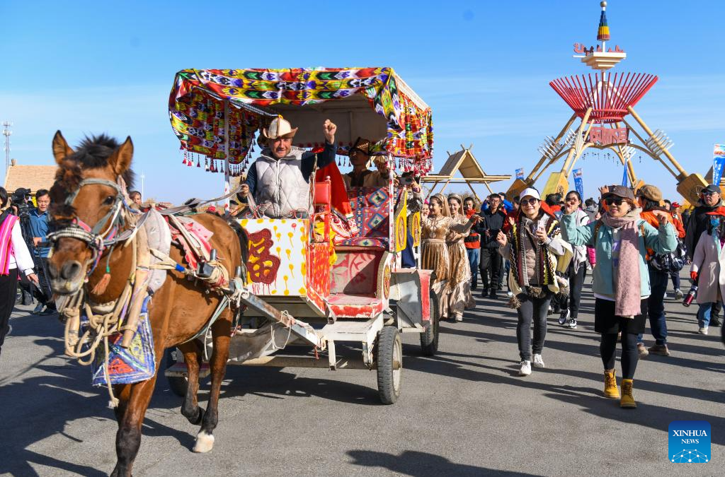 People visit desert poplar forest in Tarim River Basin of Xinjiang