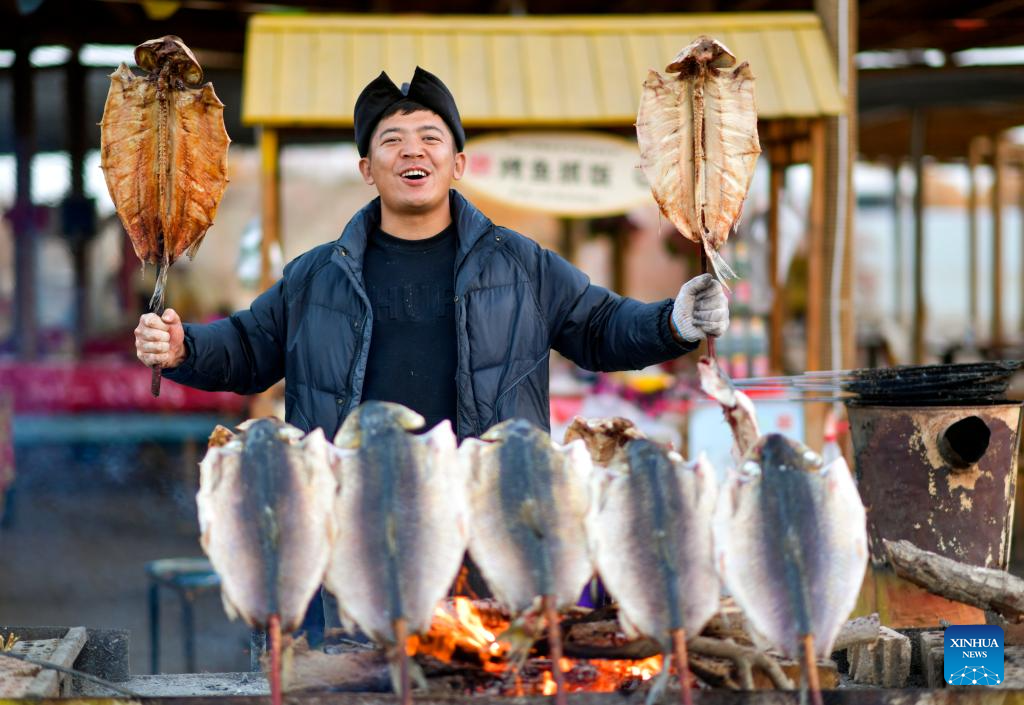 People visit desert poplar forest in Tarim River Basin of Xinjiang