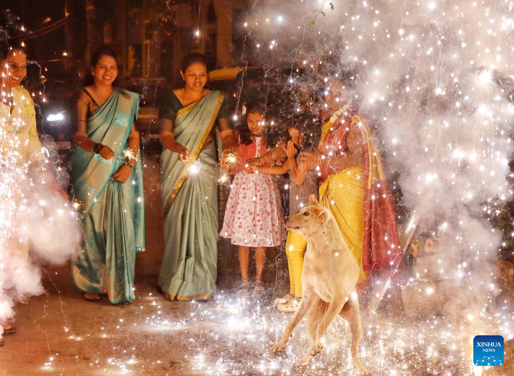 People play with firecrackers to celebrate Diwali in India
