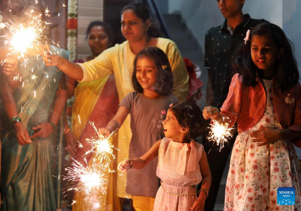 People play with firecrackers to celebrate Diwali in India