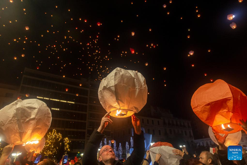 People release sky lanterns at Kotzia square in Greece