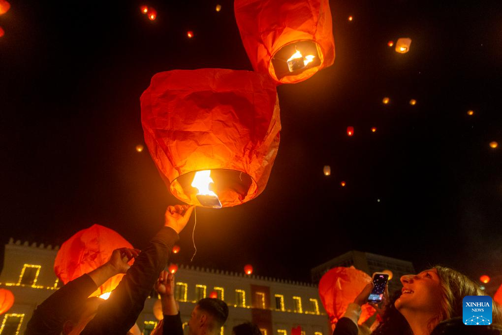 People release sky lanterns at Kotzia square in Greece